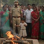 ASP's wife found hanging, 1.5-year-old toddler lights pyre; public anger flares upon husband's arrival.