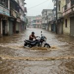 Mahoba: Four-foot deep water fills road in Kharela due to rain, youth swept away with bike.