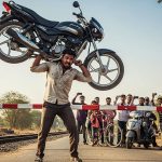 Long wait at the railway gate! Frustrated man lifts 112 kg bike on his shoulder, video goes viral!
