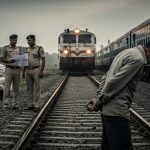 Police arrived with summons, van driver, out of fear, jumped in front of a train and died; the case was linked to a child's death.